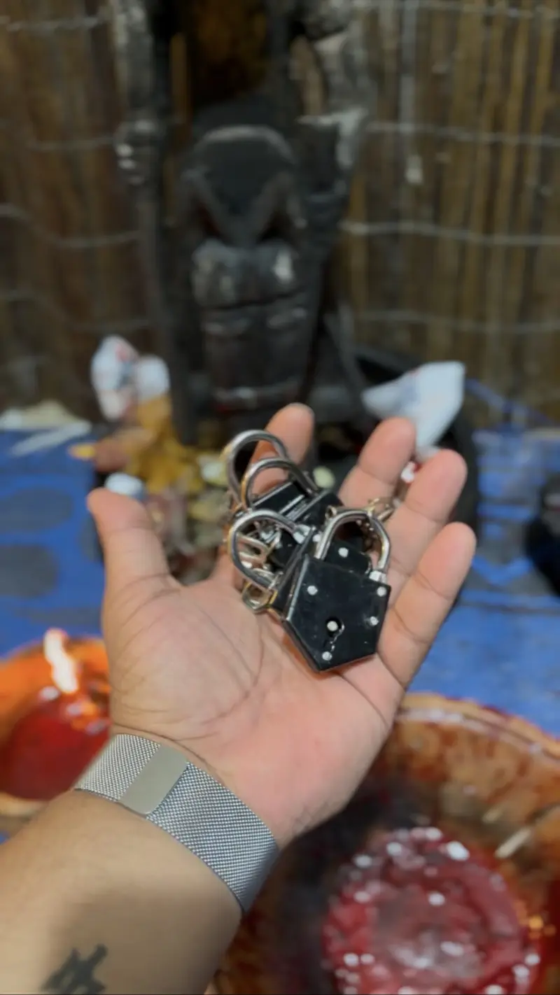 Cadeados de Agadagodo na mão do sacerdote, identificados pelo proprietário.